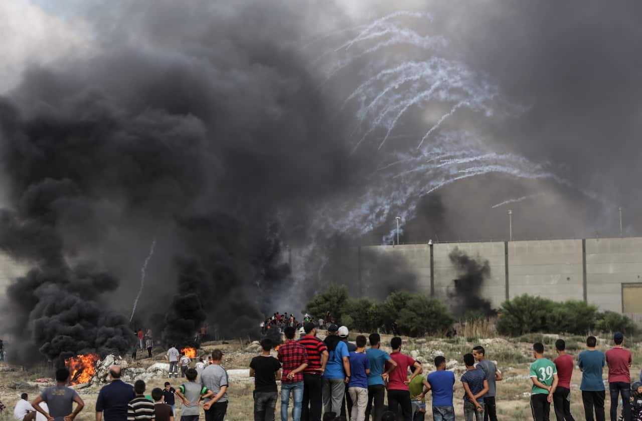 Palestinians protesters take part during the clashes with Israeli troops near the border with Israel in the east of Gaza City on, 20 July 2018.