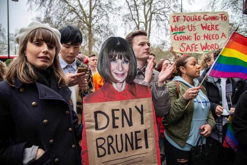 Protesters gather outside the Dorchester Hotel.