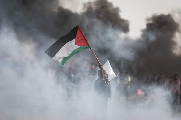 Israeli forces use tear gas to disperse Palestinian demonstrators taking part in the "Great March of Return" on Friday.