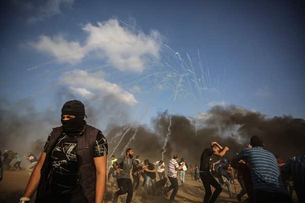 Tear gas drops among Palestinian demonstrators.