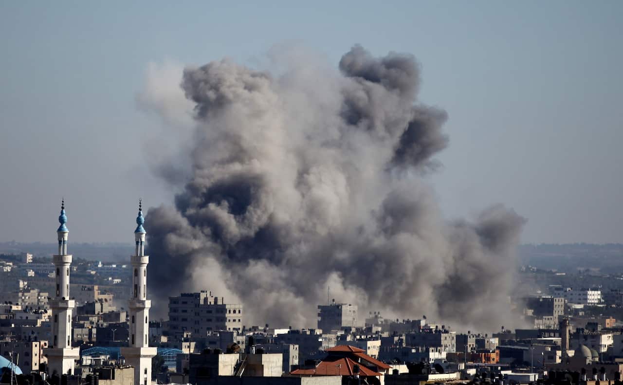 Smoke billows from buildings following an Israeli air strike in Gaza City 