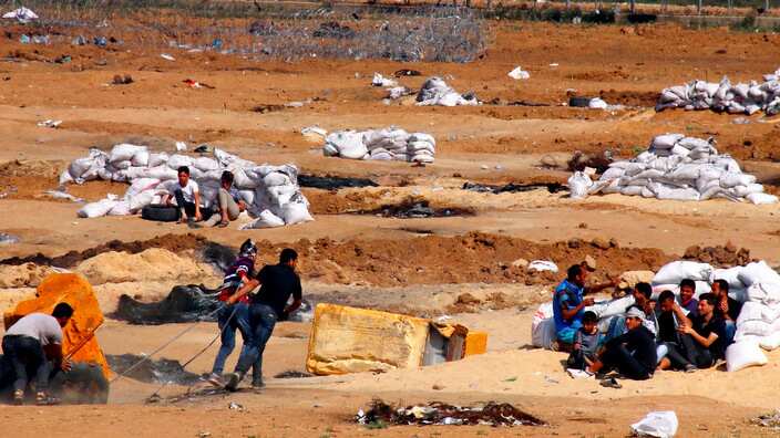 Palestinian people gather near the Gaza border with Israel on May 15, 2018. 