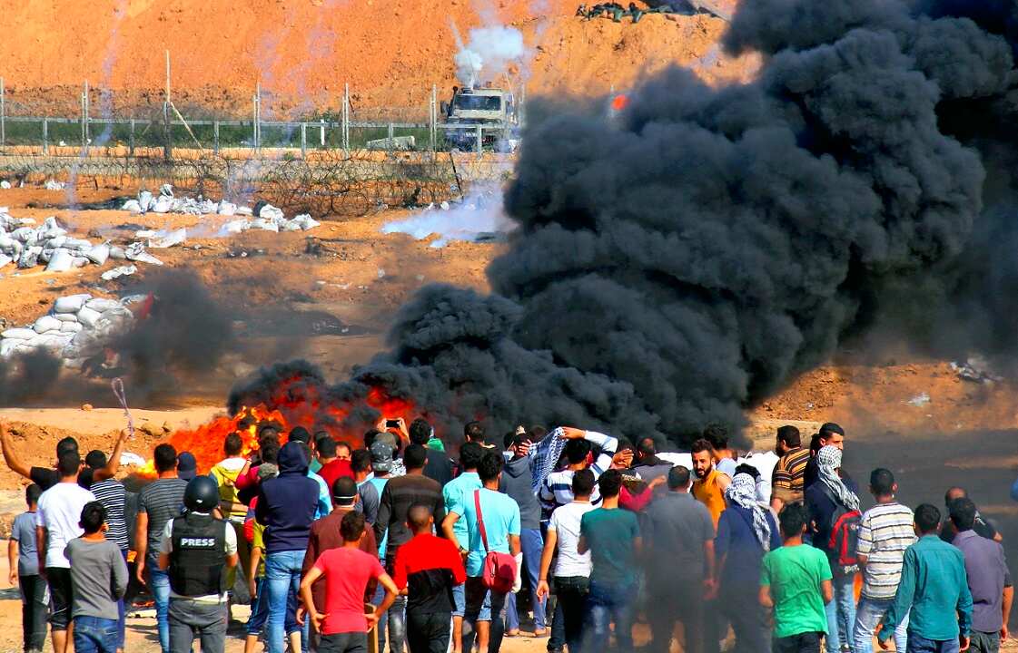 Tear bombs are thrown to Palestinian people gathering near the Gaza border with Israel on May 15, 2018. 