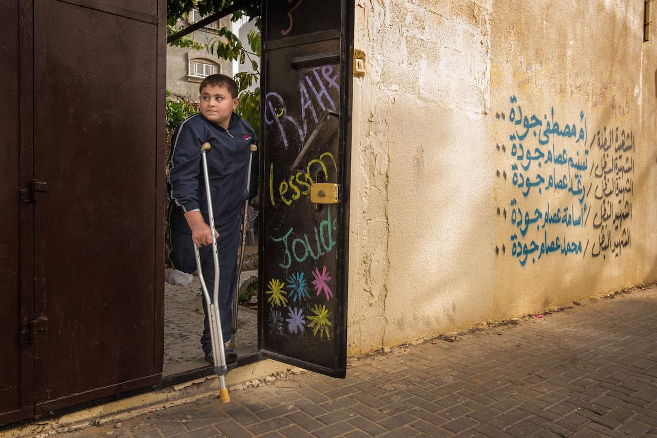 Outside in the small laneway beside the house the names of Issam’s wife and other children are painted on the wall as a memorial. 