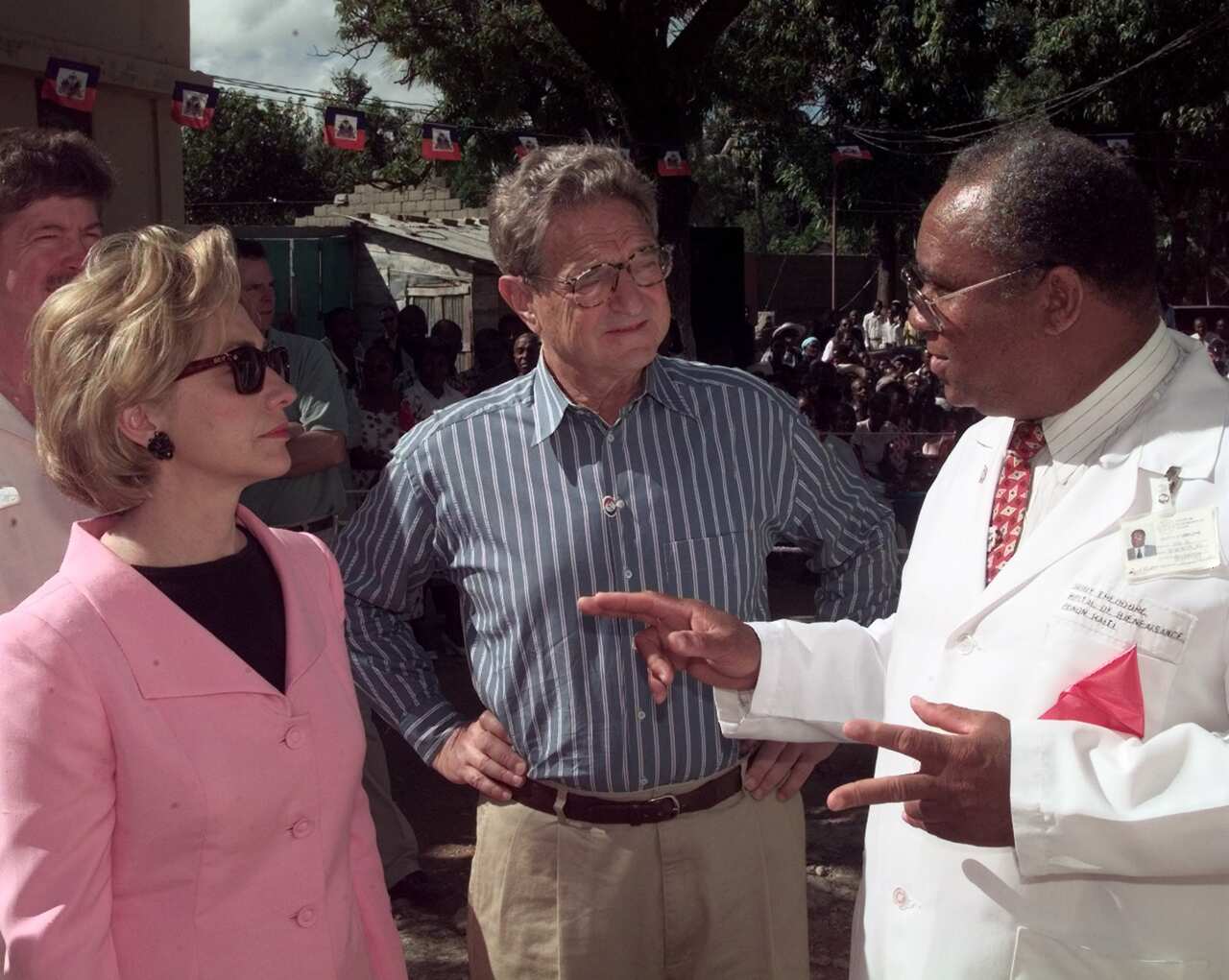 Then-First lady Hillary Clinton and international financier and philanthropist George Soros listen as Dr. Guy Theodore in 1998.