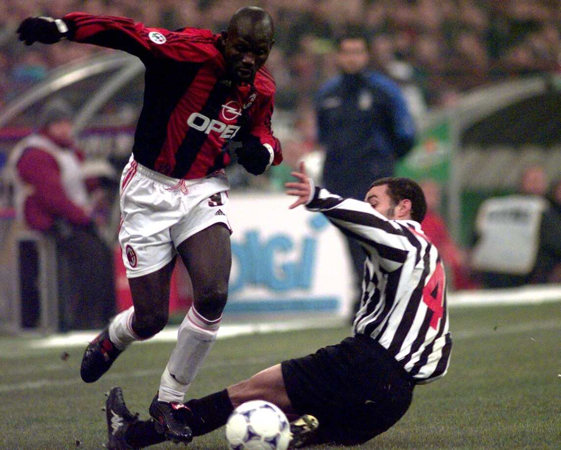 AC Milan striker George Weah, left, dribbles past Juventus Uruguayan defender Paolo Montero in 1999 (AAP)
