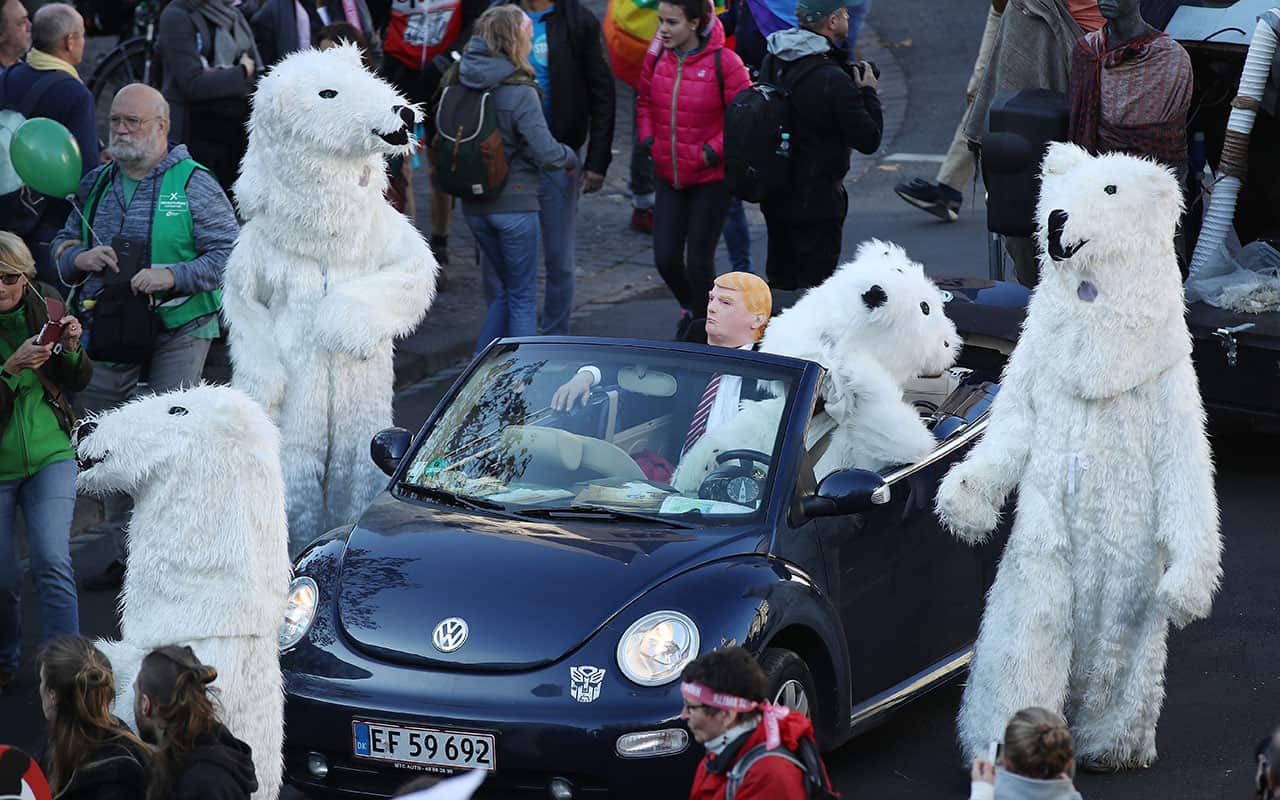 Climate change activists, including one dressed as U.S. President Donald Trump surrounded by polar bears.