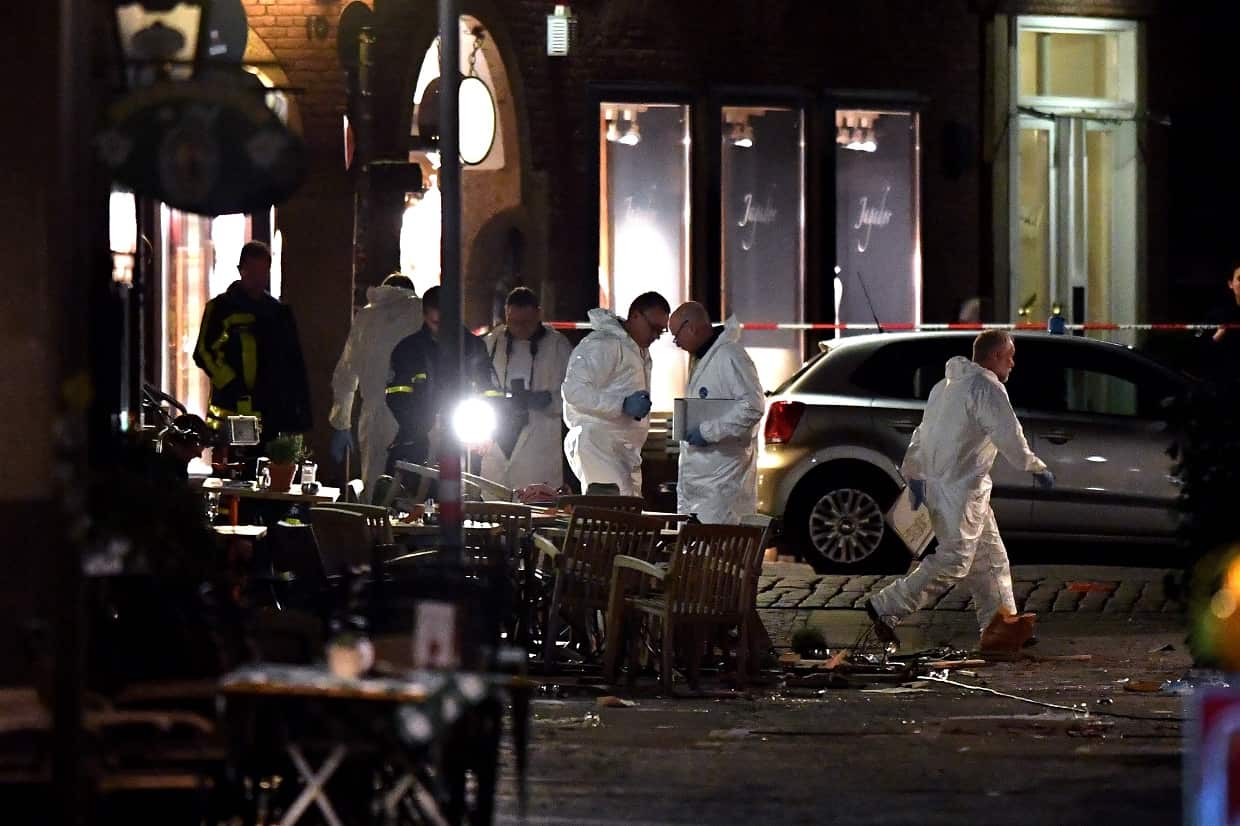 Forensics scour the scene outside the restaurant on Saturday night.