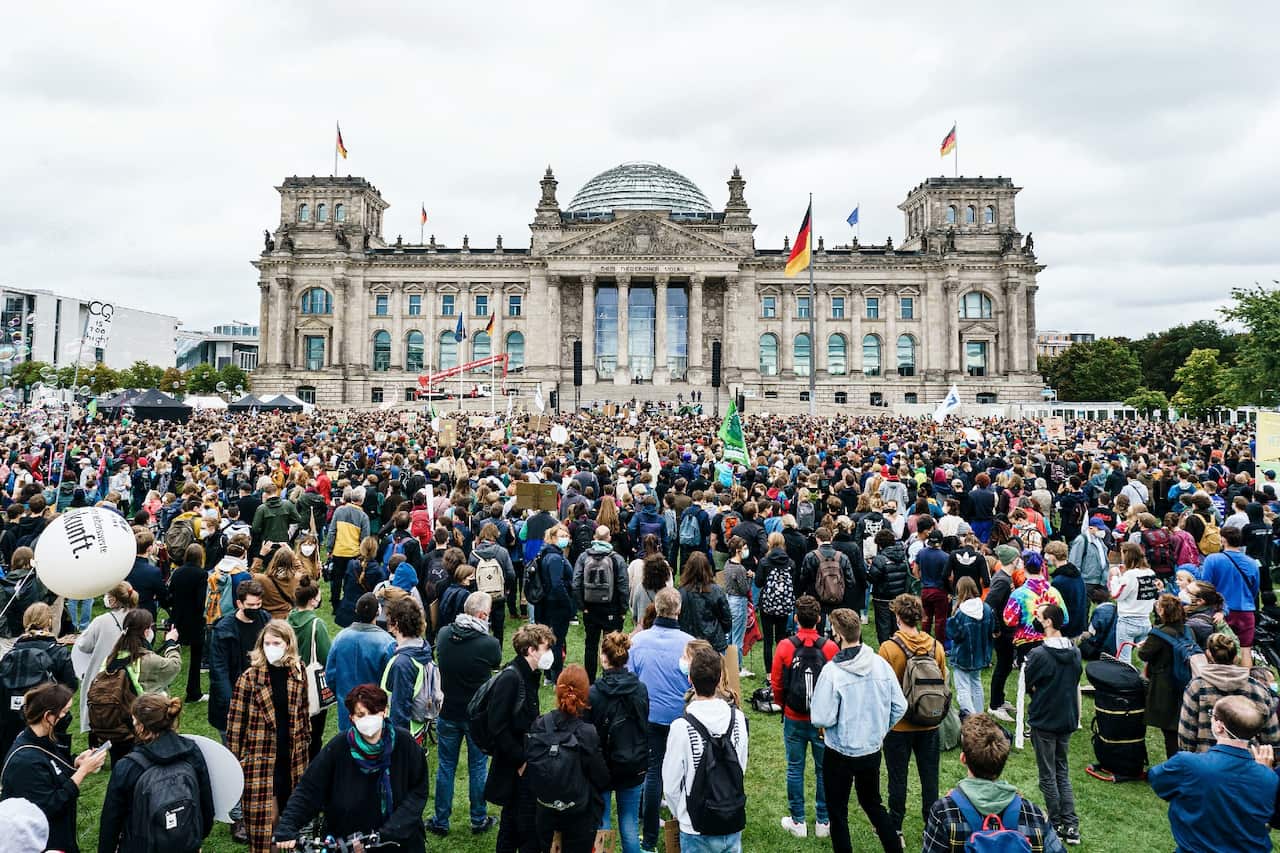 Climate change protesters gather in front of the Reichstag building in Berlin, Germany on 24 September 2021.