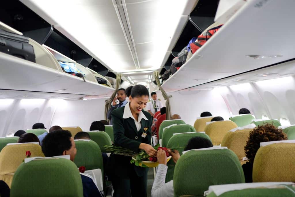 Passengers are welcomed by cabin crew inside an Ethiopian Airlines flight who departed from the Bole International Airport in Addis Ababa, Ethiopia, to Eritrea's capital Asmara on July 18, 2018.