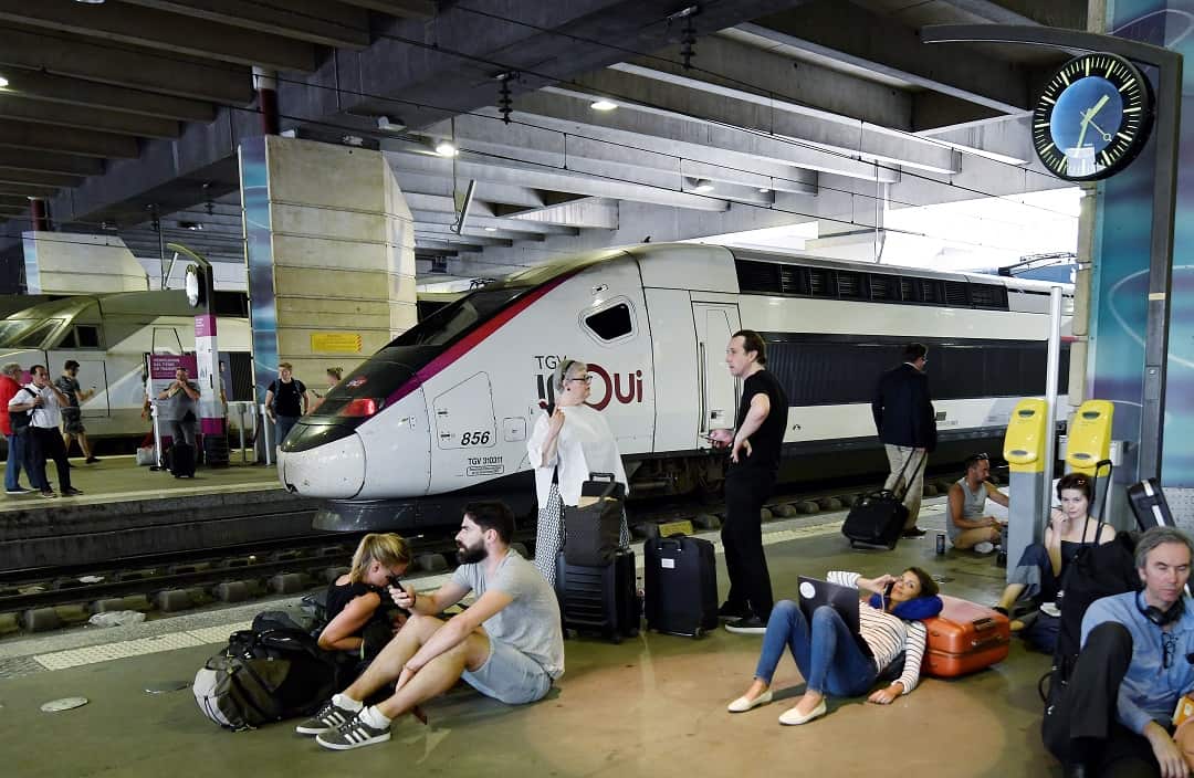 People wait on a platform of the Montparnasse railway station.