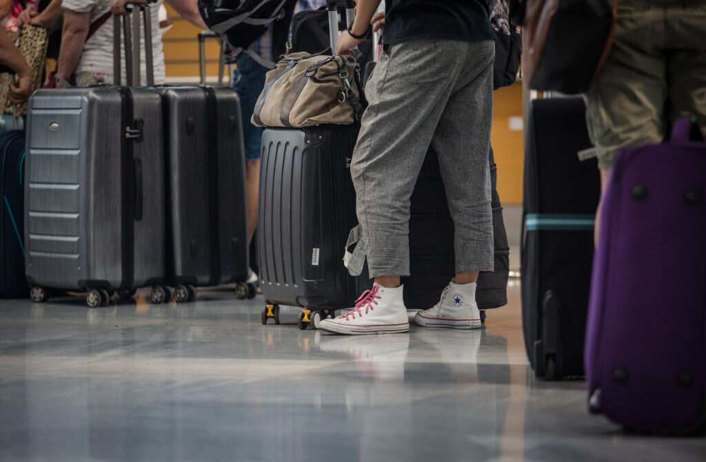 Passengers waiting to check in their luggage at the terminal of Stuttgart Airport. 