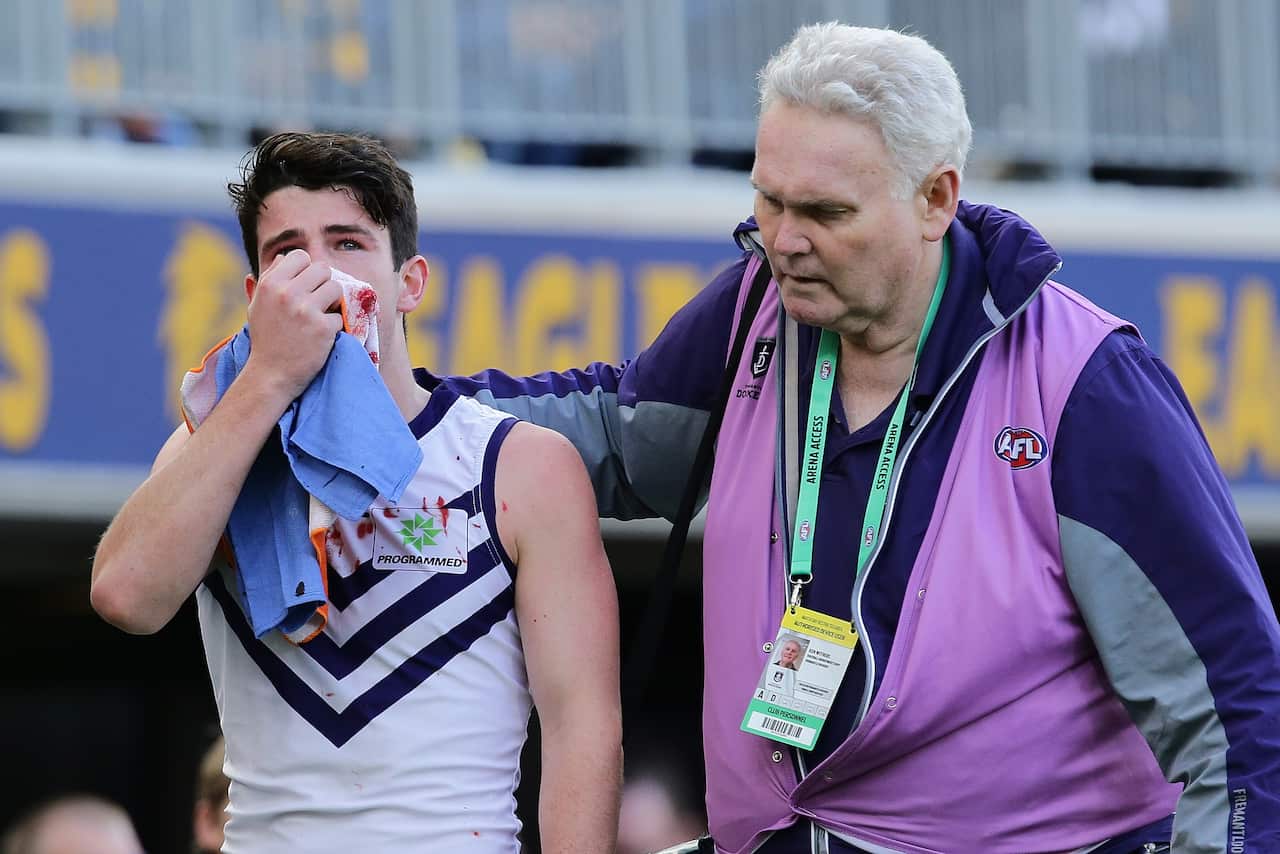 Andrew Brayshaw of the Dockers leaves the field with a broken jaw from contact with Andrew Gaff during the AFL match between West Coast Eagles and Fremantle