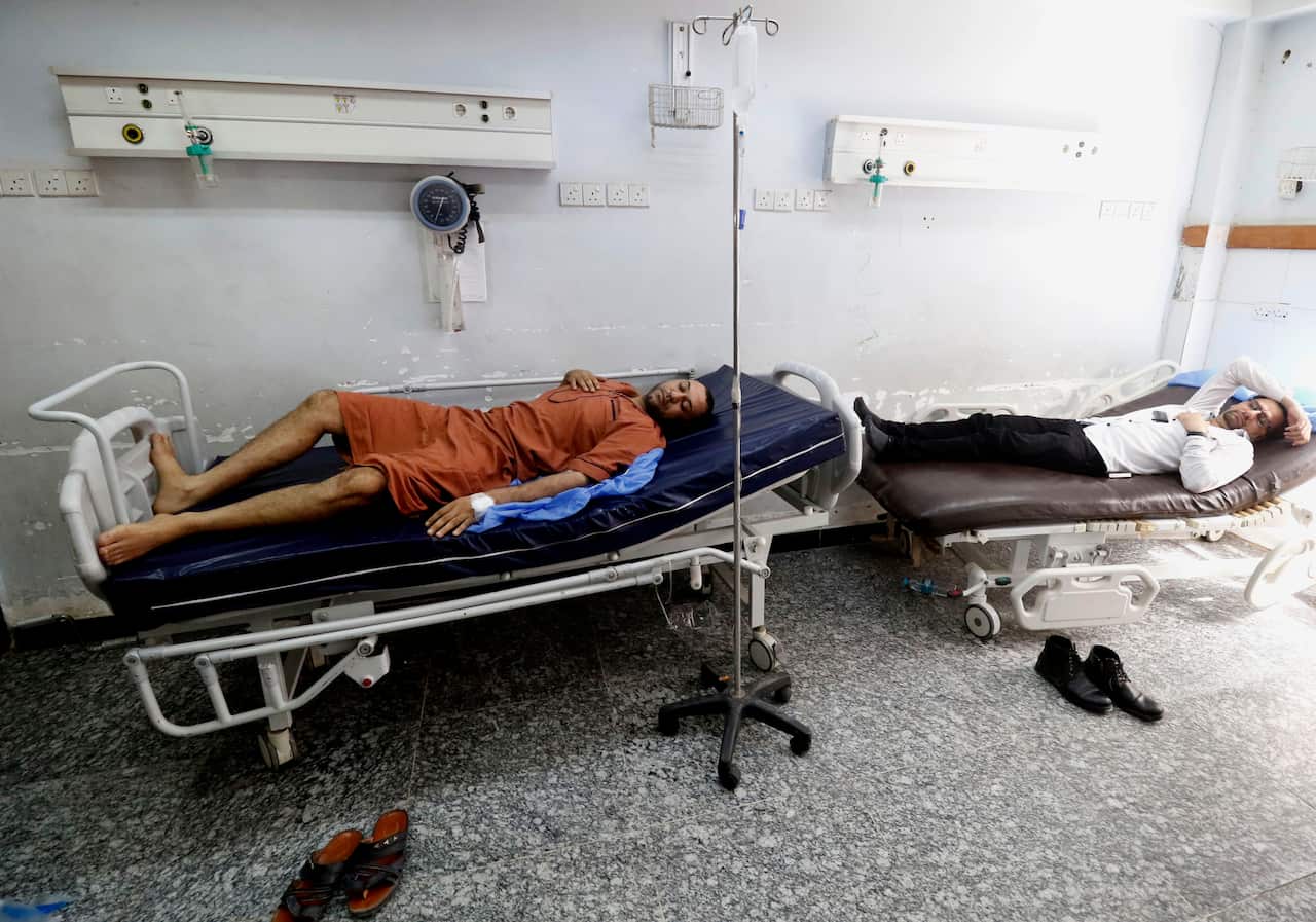 Iraqi men lie at a hospital in Basra in southern Iraq, on August 29, 2018, after falling ill from drinking polluted tap water.