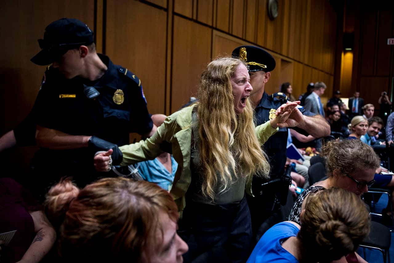 A protester is removed by Capitol police during the hearing of Supreme Court nominee Brett Kavanaugh.