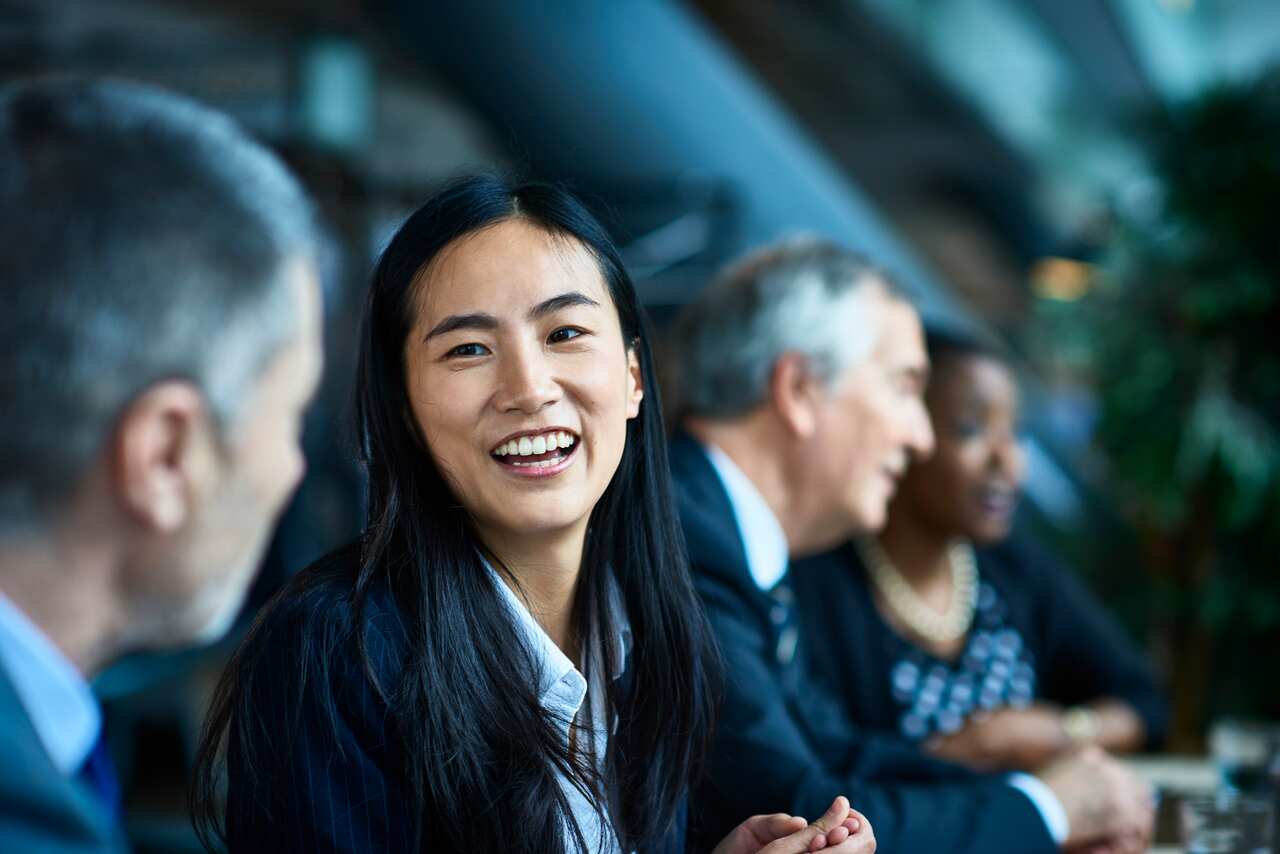 Cheerful relaxed businesswoman with manager in meeting