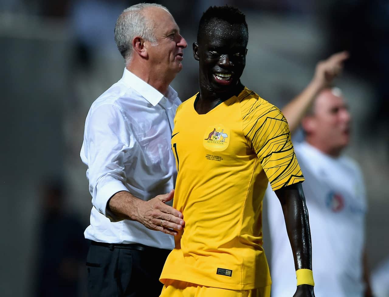 Awer Mabil with his coach Graham Arnold.