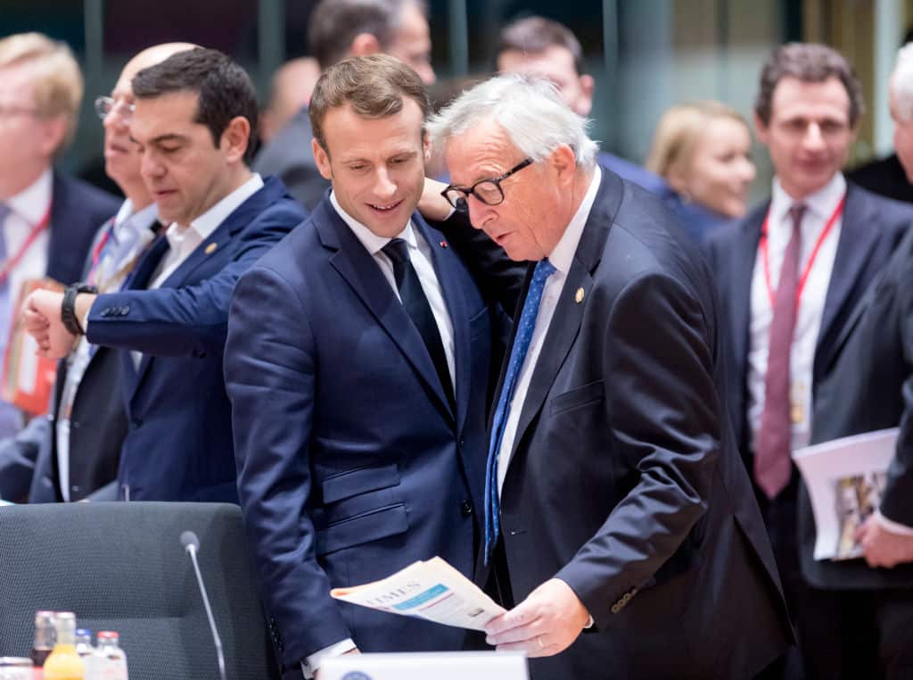 French President Emmanuel Macron speaks with the President of the European Commission Jean-Claude Juncker during the EU chief of state summit in Brussels, Belgium.