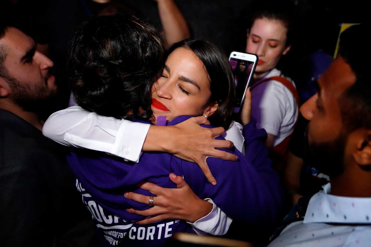 Alexandria Ocasio-Cortez hugs a supporter after her victory.
