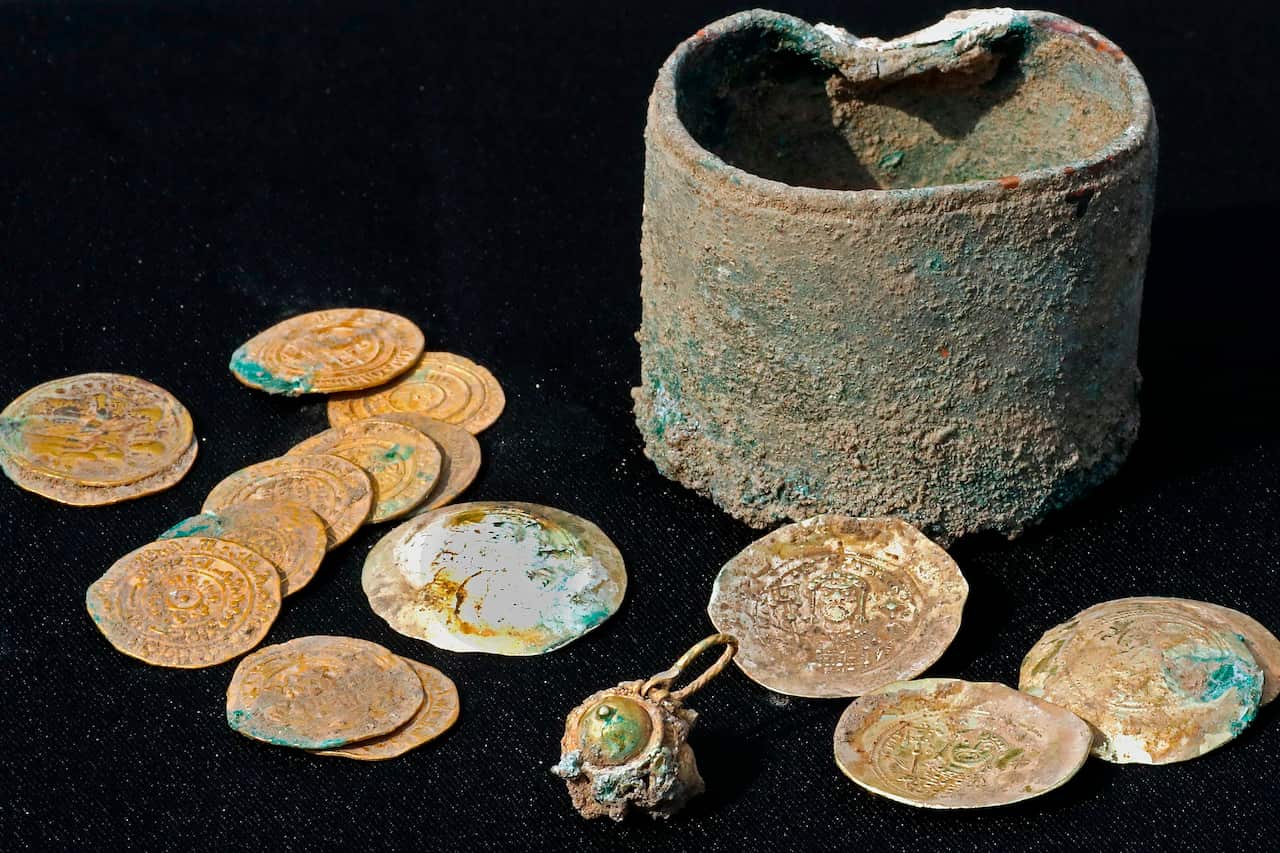 Ancient gold coins and an earring recently uncovered at an excavation site in the Israeli Mediterranean town of Caesarea