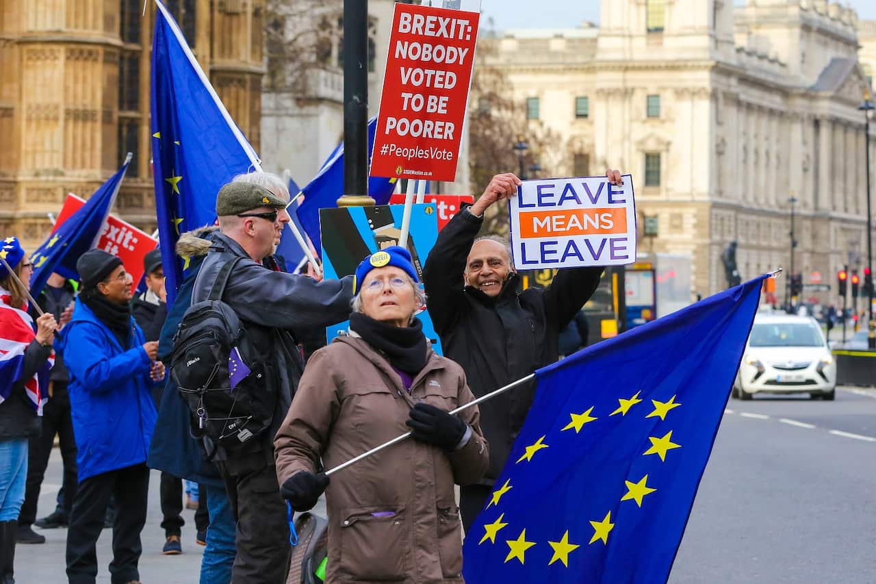 Anti Brexit protesters seen with their placards and EU flag