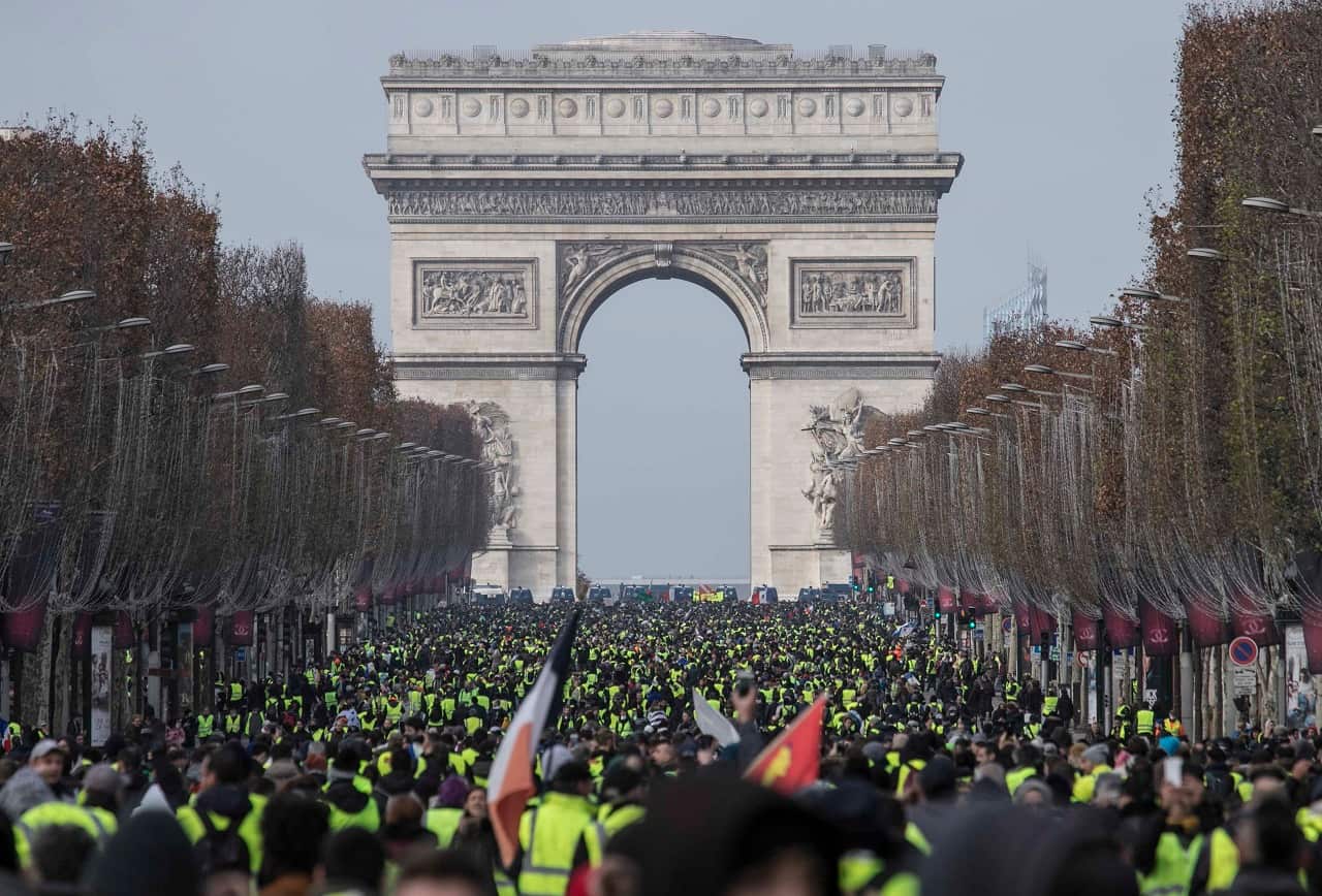 Thousands of yellow vest protesters seen in front of Arc De Triomphe in Paris.