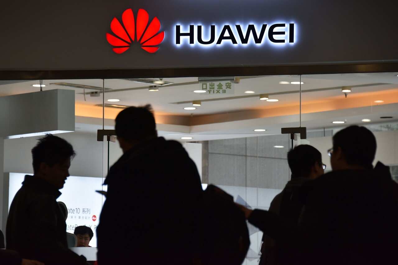 People walk past a Huawei store in Beijing.