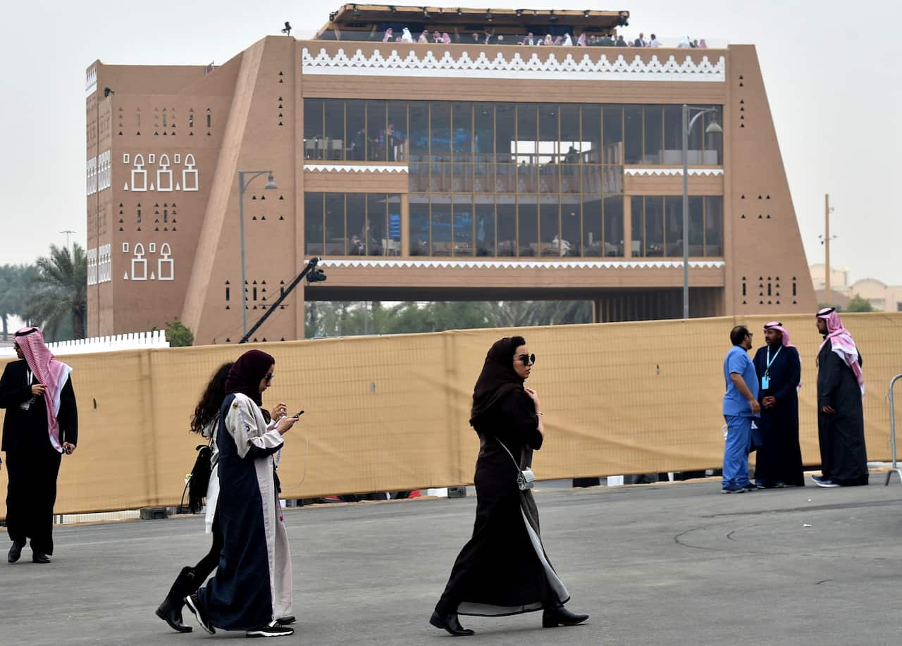 Saudi women walk pior to the 2018 Saudia Ad Diriyah E-Prix Formula E Championship in Riyadh, on December 15, 2018 in Riyadh. (Photo by FAYEZ NURELDINE / AFP)        (Photo credit should read FAYEZ NURELDINE/AFP/Getty Images)