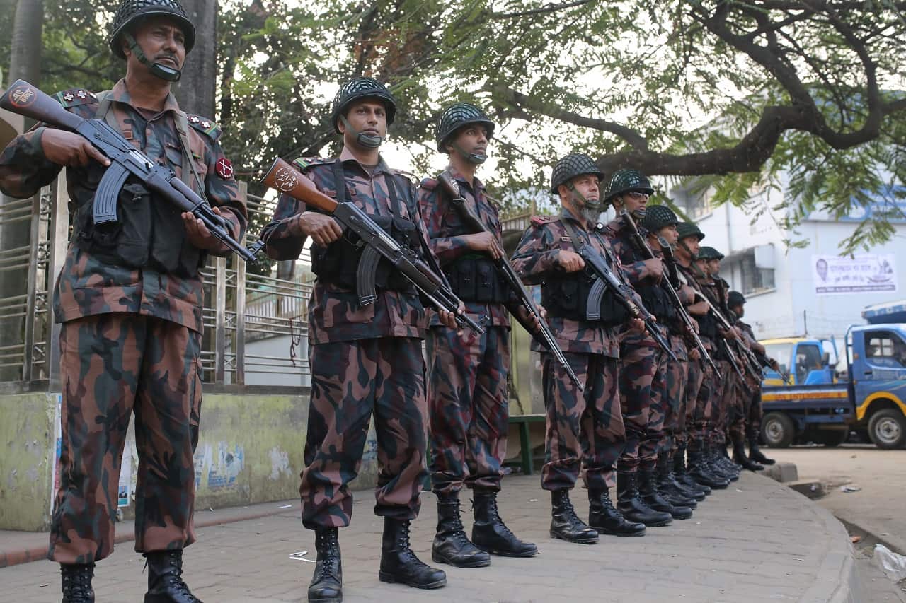 Members of Border Guard Bangladesh (BGB) stand guard on a street ahead of the general election.