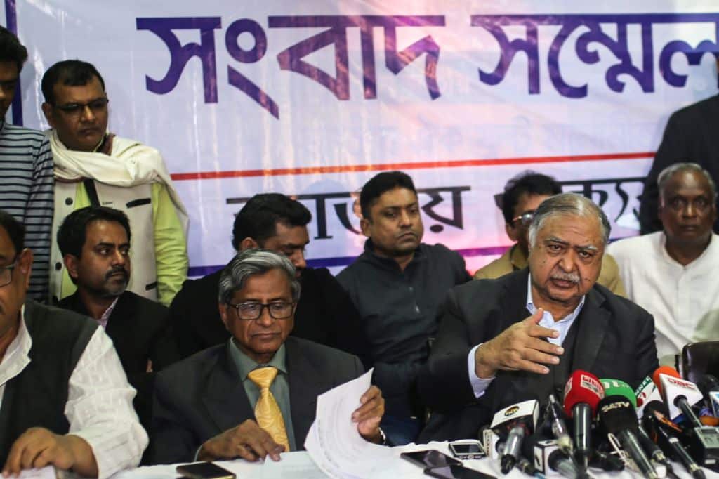 Kamal Hossain (R), speaks to the media in Dhaka.