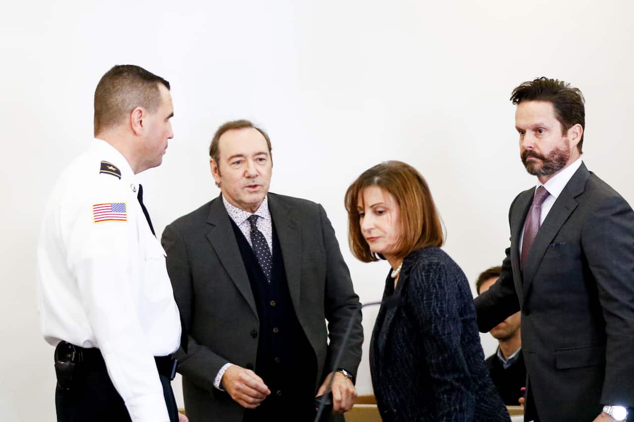 Kevin Spacey is escorted with his lawyers Juliane Baliro and Alan Jackson during his earlier arraignment for sexual assault charges at Nantucket District Court