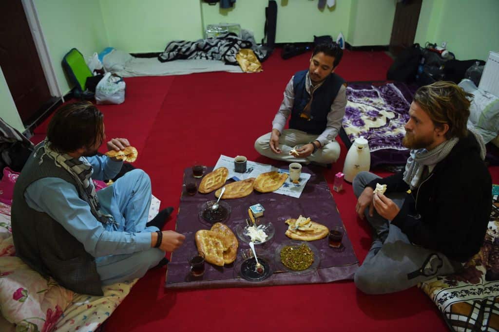 Afghan Couchsurfing host Naser Majidi eats breakfast with his guests.