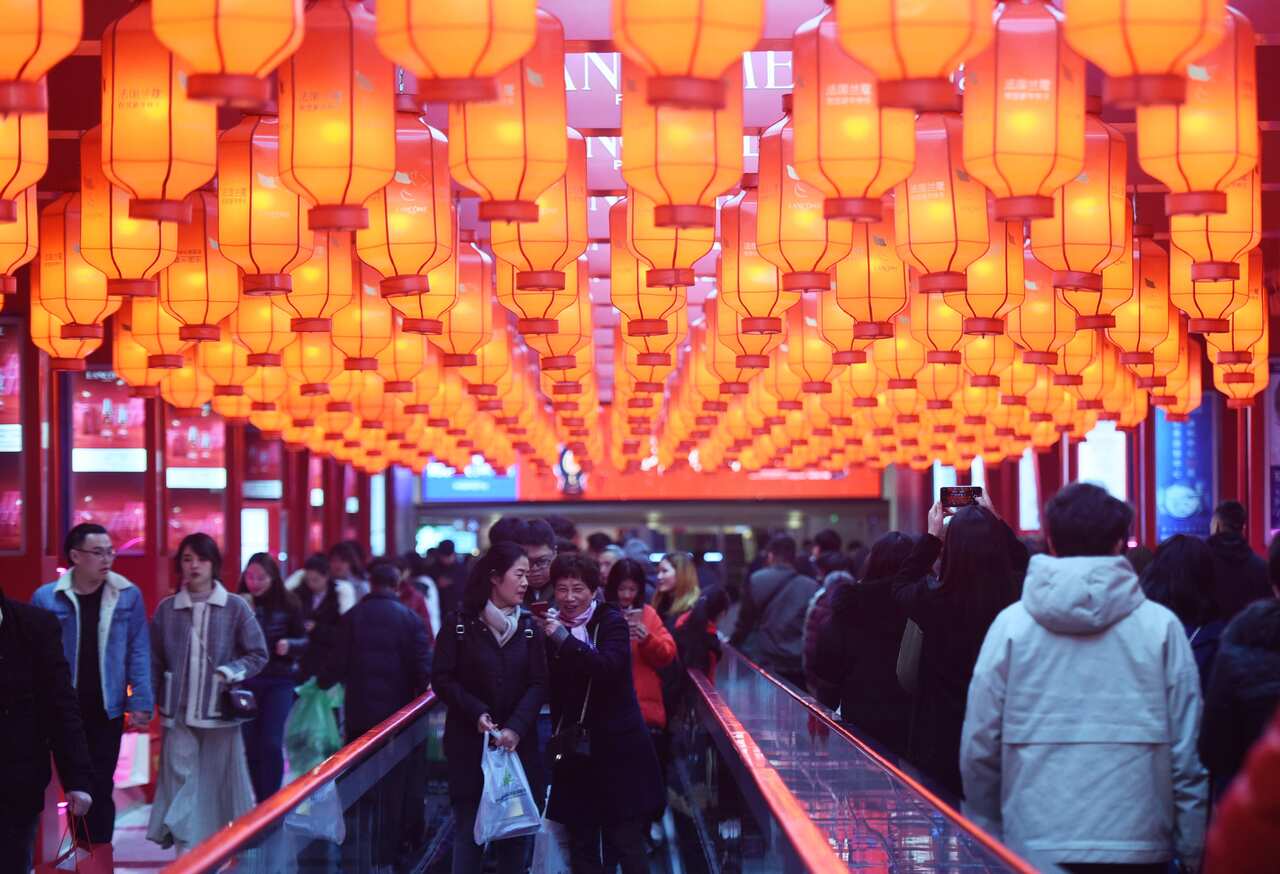 In Hangzhou, crowds enjoy thousands of red lanterns just lit on a footbridge to welcome the  Spring Festival, which runs for 40 days. 