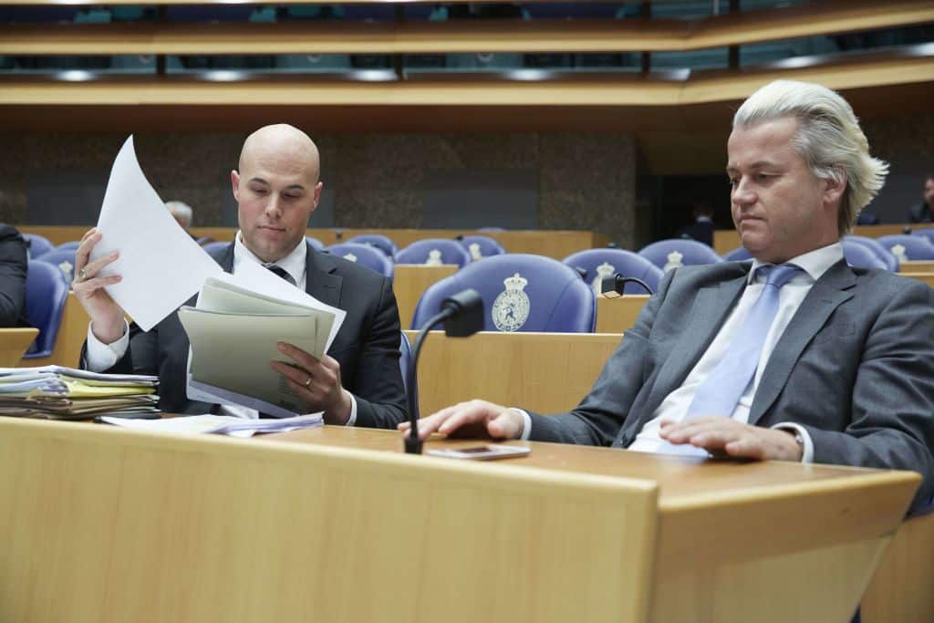 PVV party members Joram van Klaveren (L) and Geert Wilders (R) at the Dutch parliament in 2013.