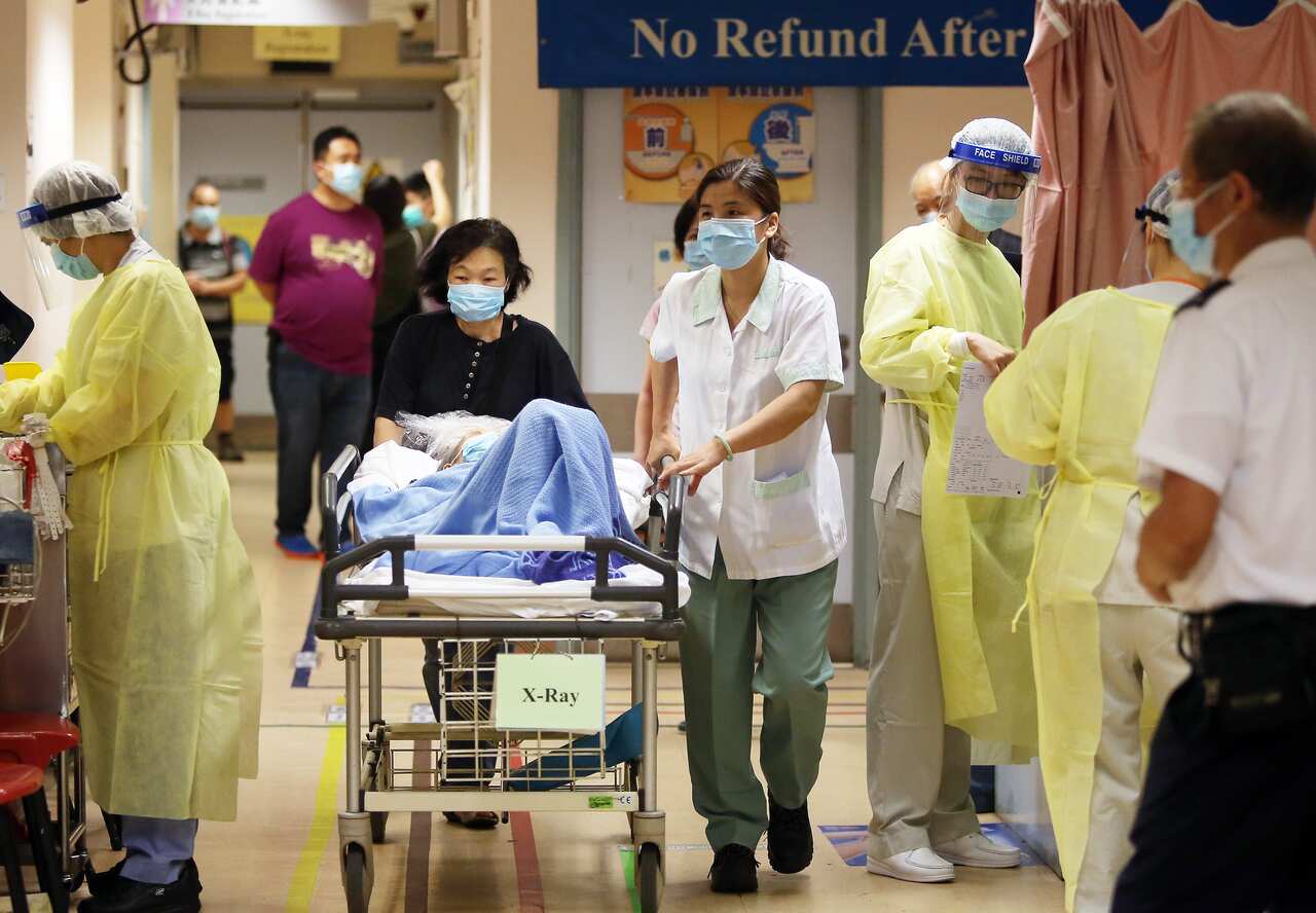 Medical staff in protective outfits take precautions with patients at Kwong Wah Hospital in Yau Ma Tei.