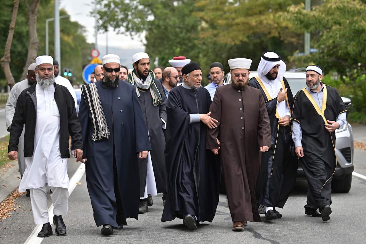 Delegates and religious leaders walk towards the Al Noor Mosque in Christchurch.