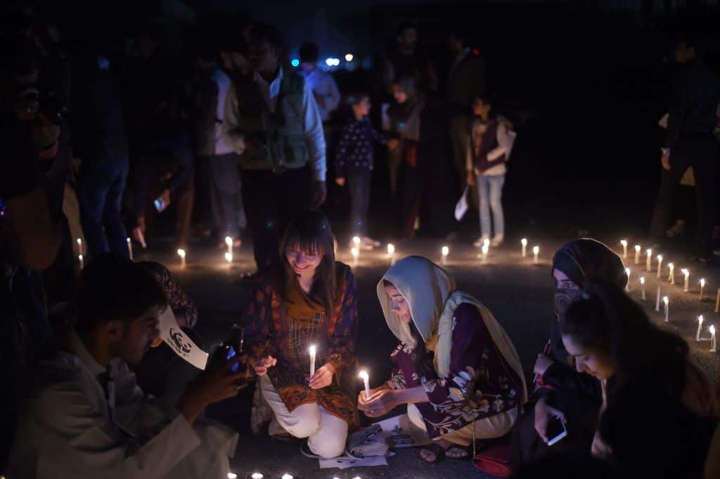 Pakistani women hold light candles in front of the parliament house during a Earth Hour in Islamabad.