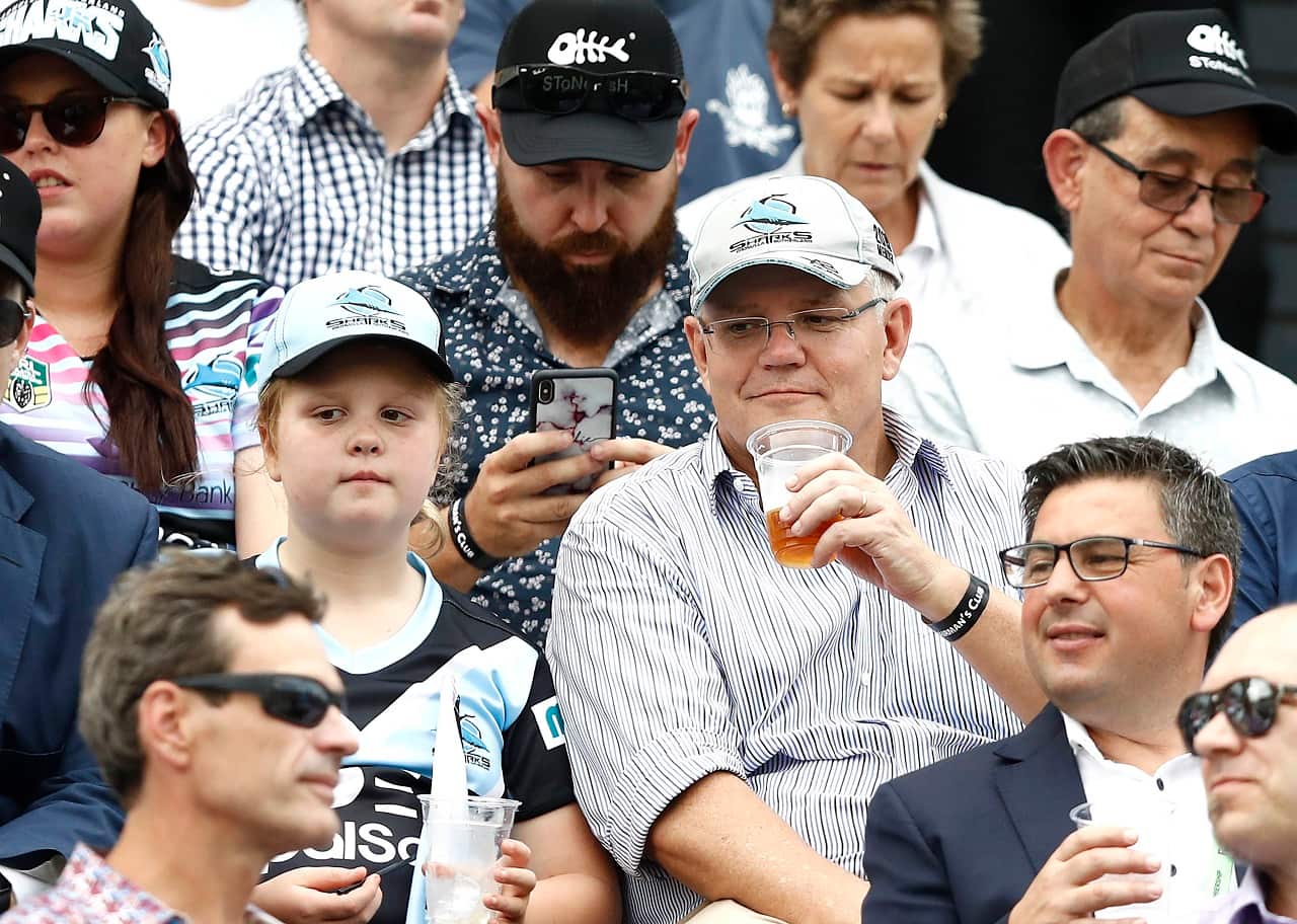 Scott Morrison has a beer at the NRL.