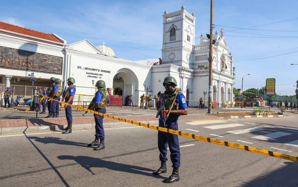 Sri Lankan soldiers stand guard in front of the St. Anthony's Shrine a day after multiple explosions.