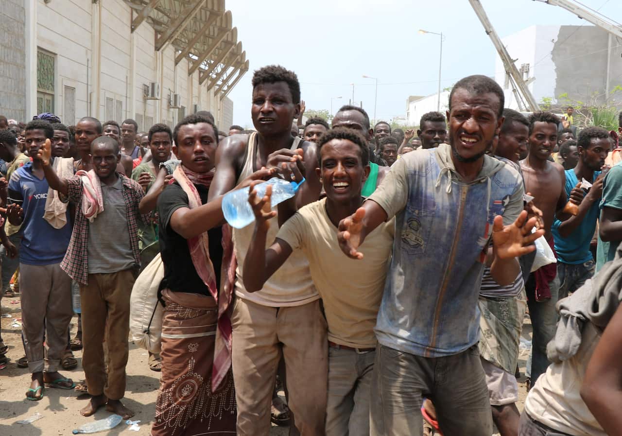 African migrants receive food and water inside a football stadium in the Red Sea port city of Aden in Yemen, on April 23, 2019.