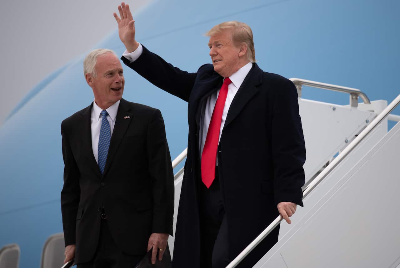 US President Donald Trump and Senator Ron Johnson disembark from Air Force One at Green Bay Austin Straubel International Airport in Wisconsin in 2019.