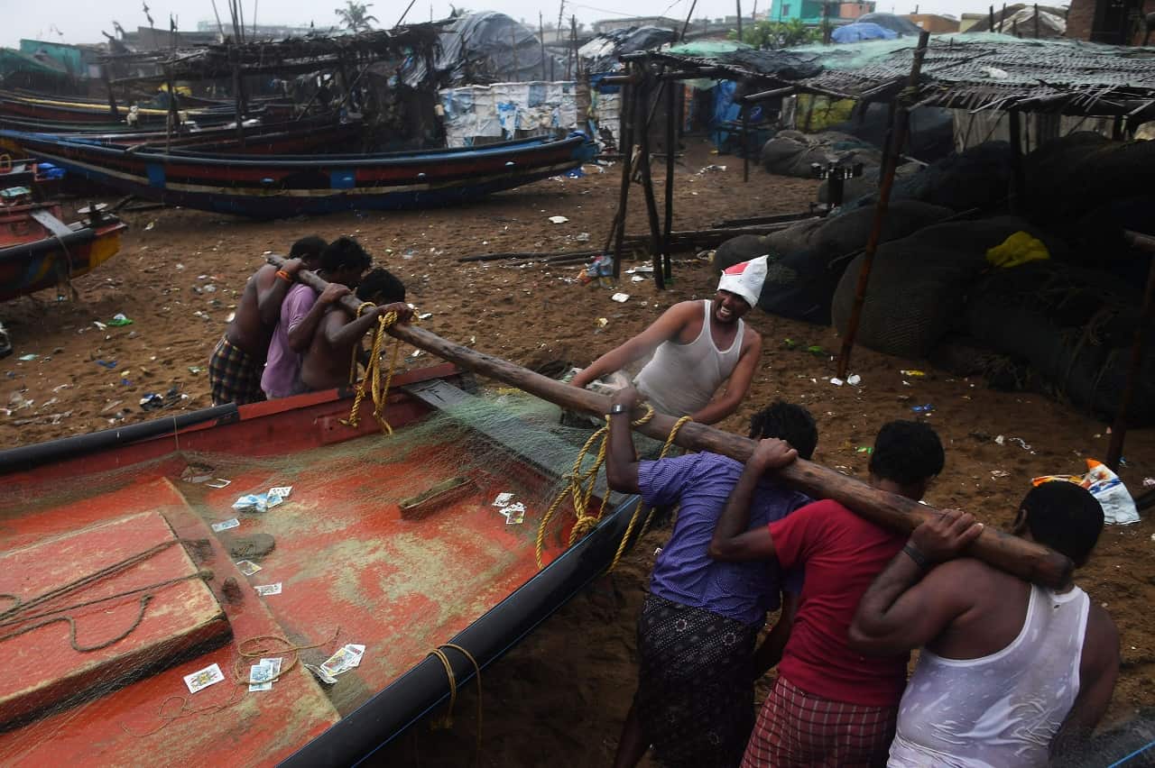 Indian fishermen pull a boat to higher ground as Cyclone Fani approached.