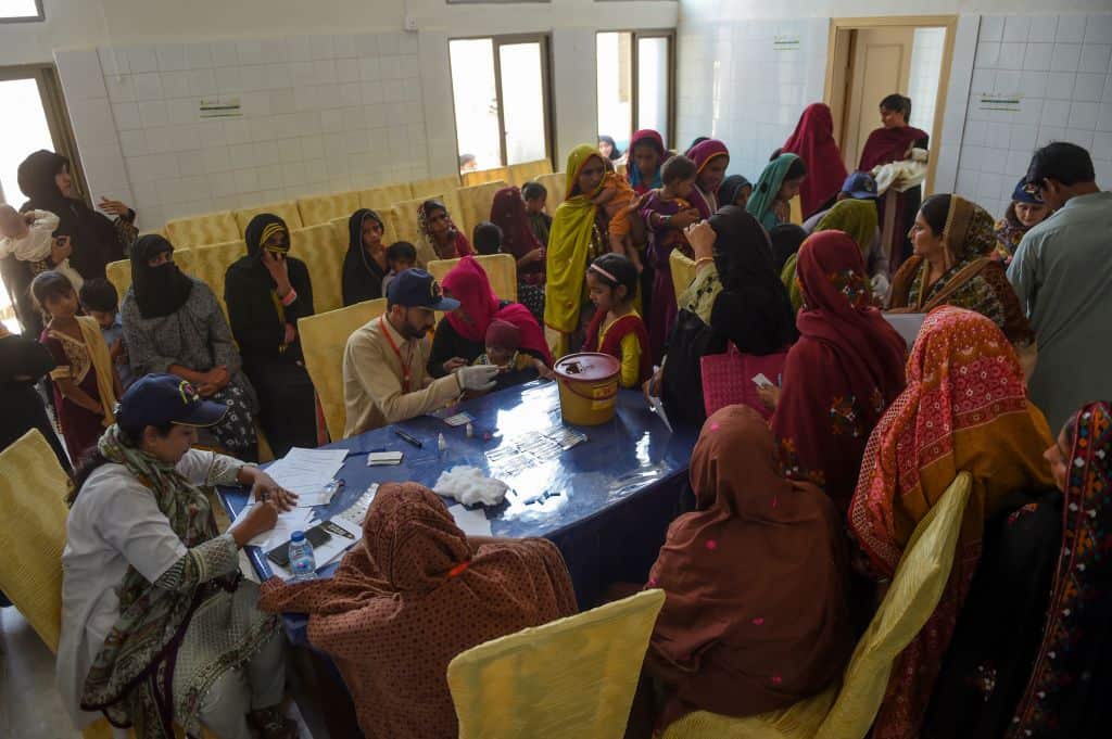 Parents nervously watch over their children as they jostle in line to be tested for HIV.