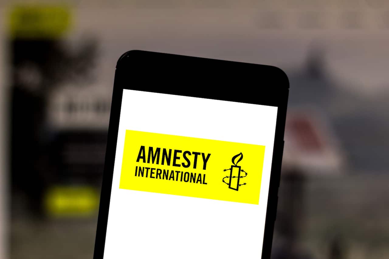 In this photo illustration a Amnesty International logo seen