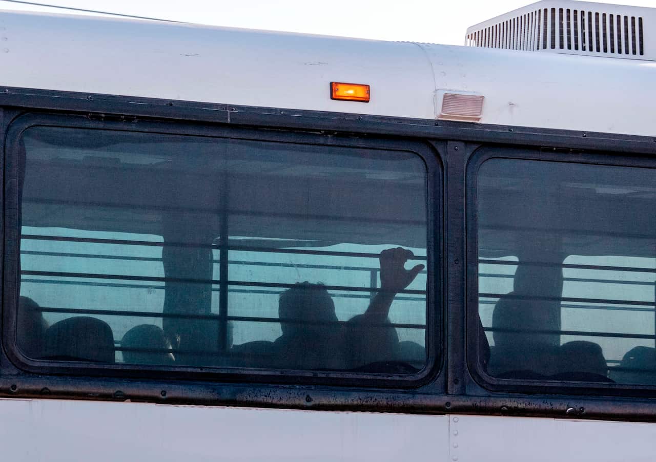 A bus transporting immigrants leaves a temporary facility at a US Border Patrol Station in Clint, Texas.