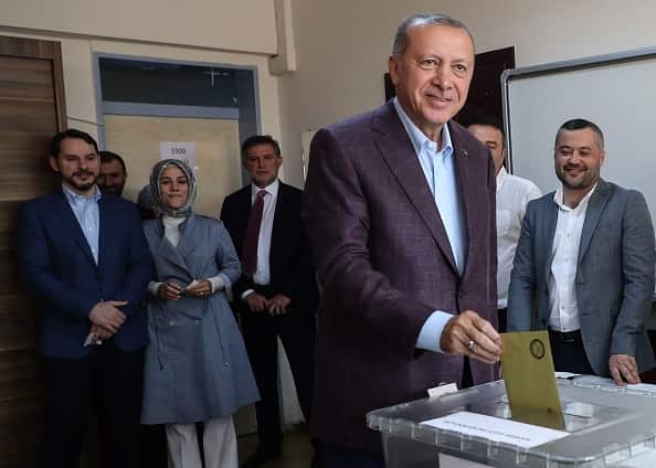 President Recep Tayyip Erdogan (2nd R) casts his vote