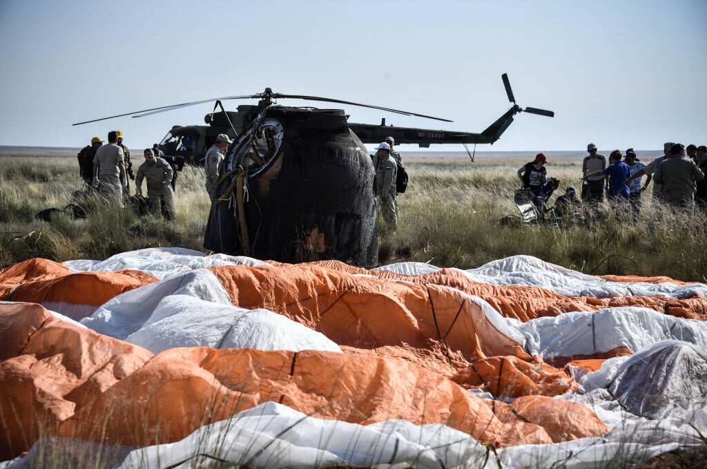 A search and rescue team works on the site of landing of the Soyuz MS-11 capsule carrying the International Space Station (ISS)