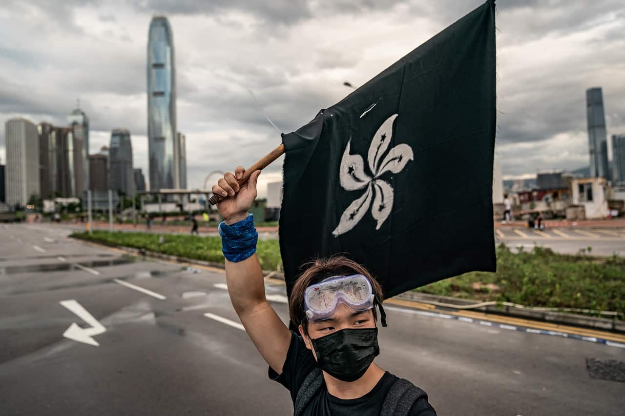 An anti-extradition protester waves a black flag.