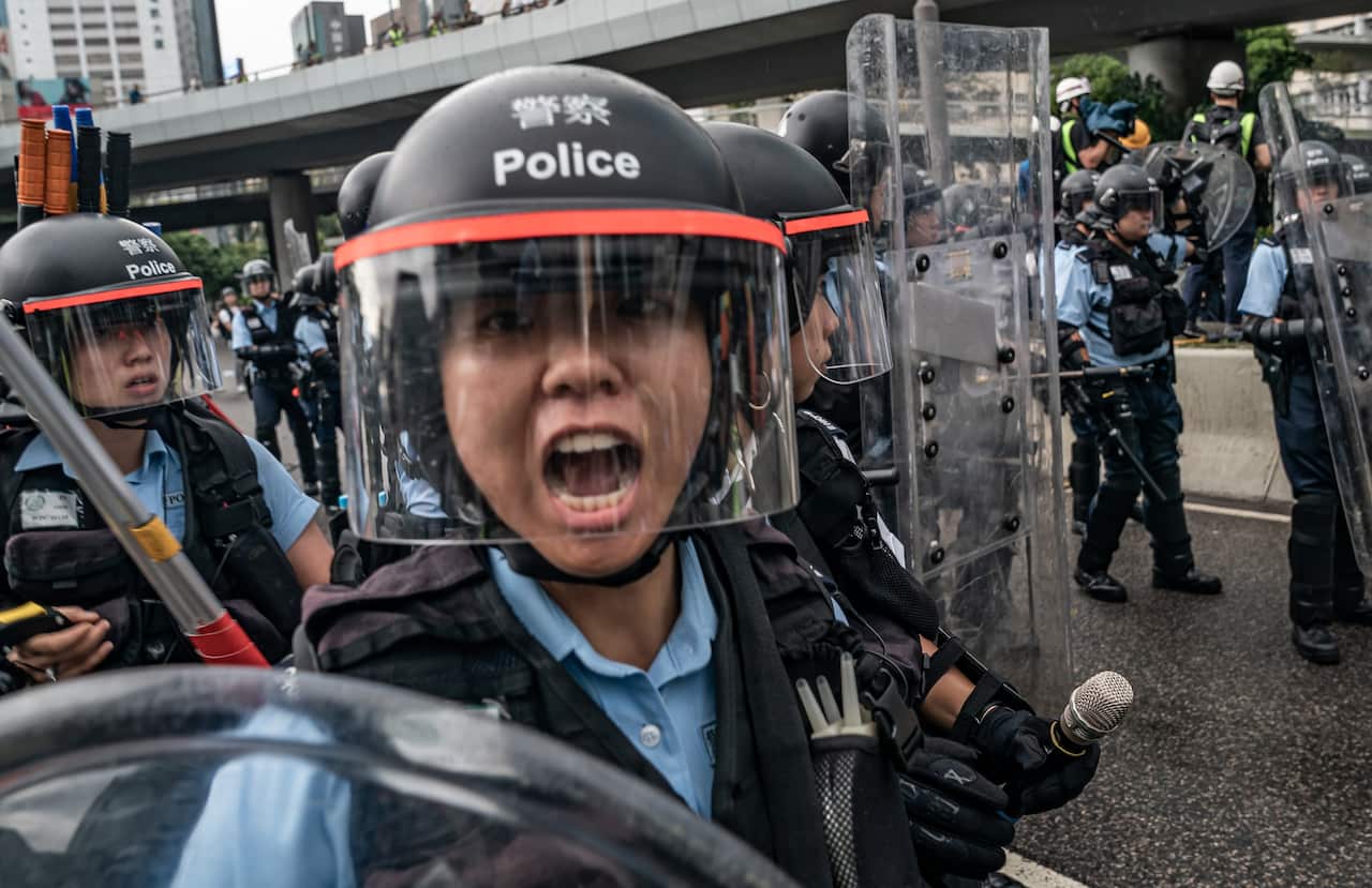 Police officers during a clash outside the Legislative Council Complex.