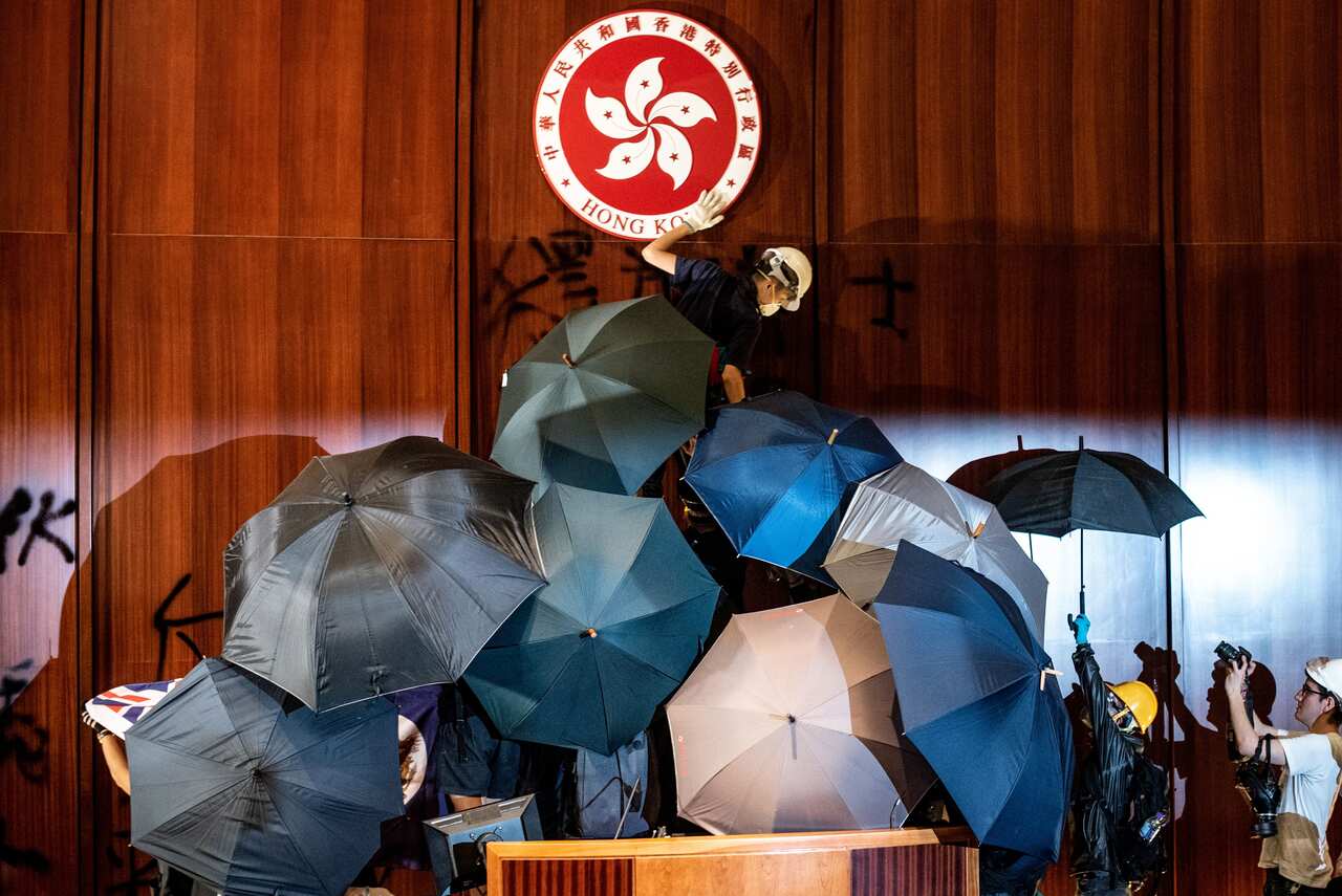 Protesters have been using umbrellas to protect themselves - and shield their identities.